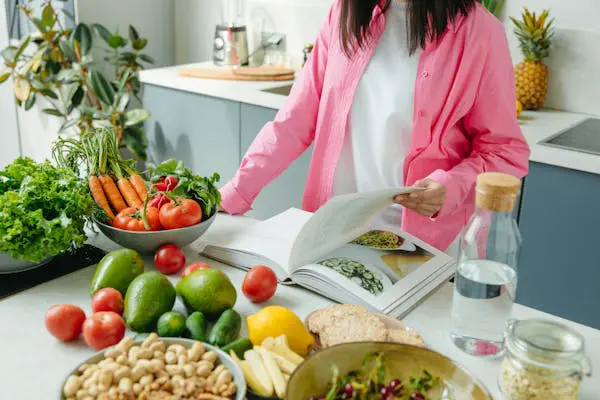 A person packing a lunchbox with an assortment of portable vegan snacks, illustrating the convenience and versatility of on-the-go vegan options from Vegan Cookbook Haven