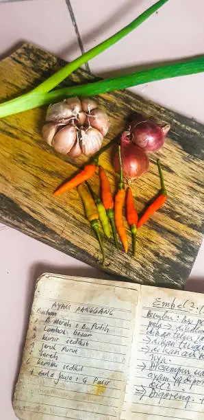 A person cooking with an array of international spices and ingredients, representing the multicultural culinary exploration of vegan cooking with recipes from Vegan Cookbook Haven