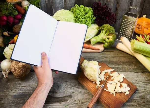 A person cooking vegan pancakes on a griddle, illustrating the indulgent and delicious nature of vegan brunch recipes from Vegan Cookbook Haven.