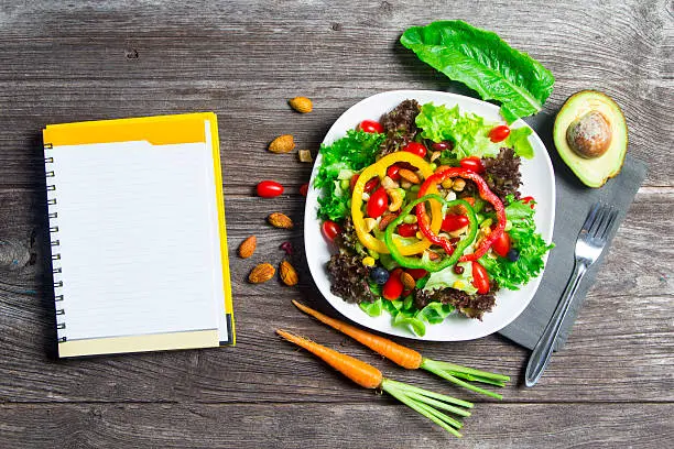 "Friends enjoying a picnic outdoors with a spread of vegan BBQ dishes, illustrating the joy and camaraderie of summer gatherings with Vegan Cookbook Haven's recipes.